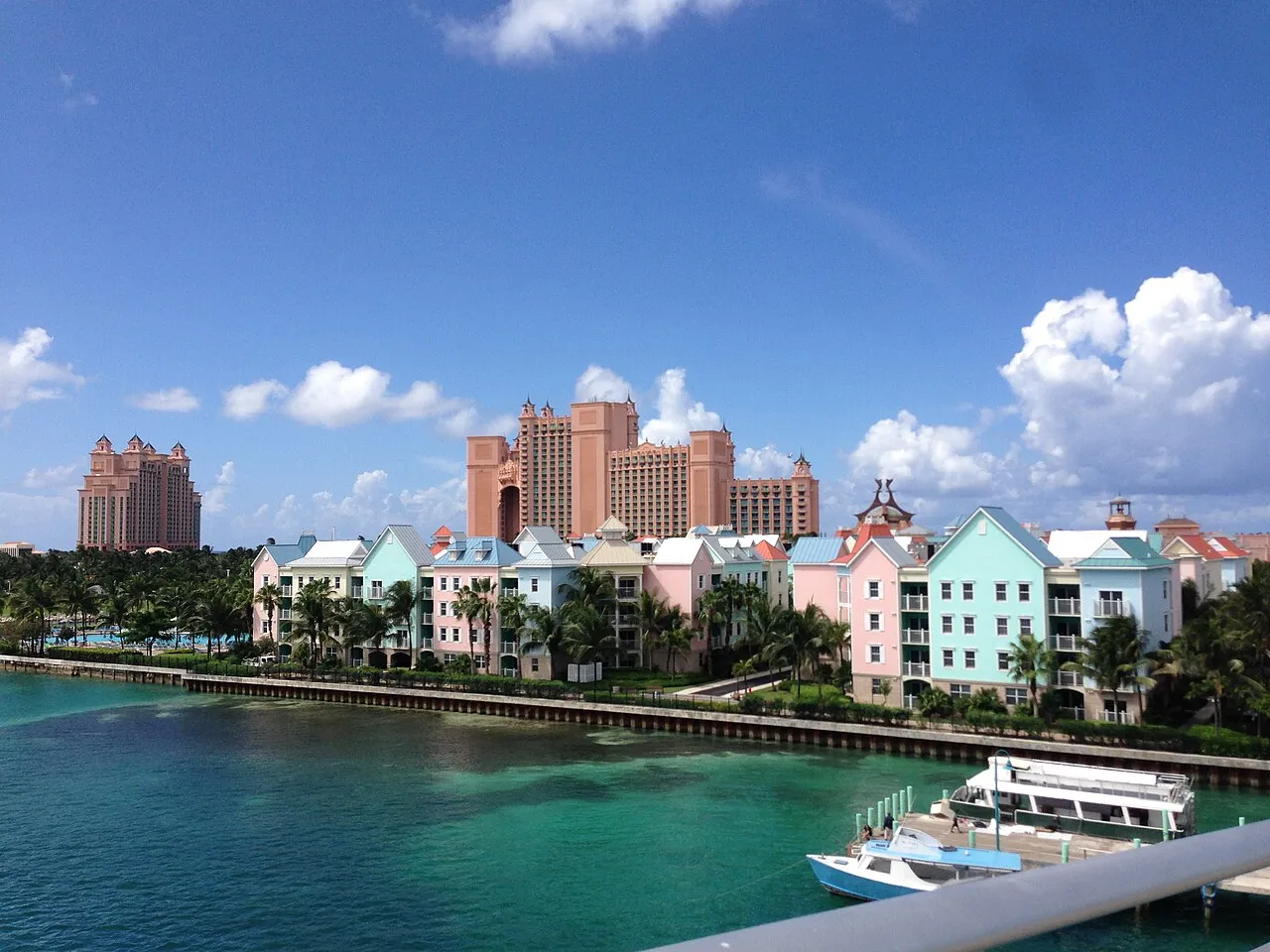 A waterfront view of the south living area of Paradise Island near Nassau, with the Atlantis resort bridge over turquoise water.