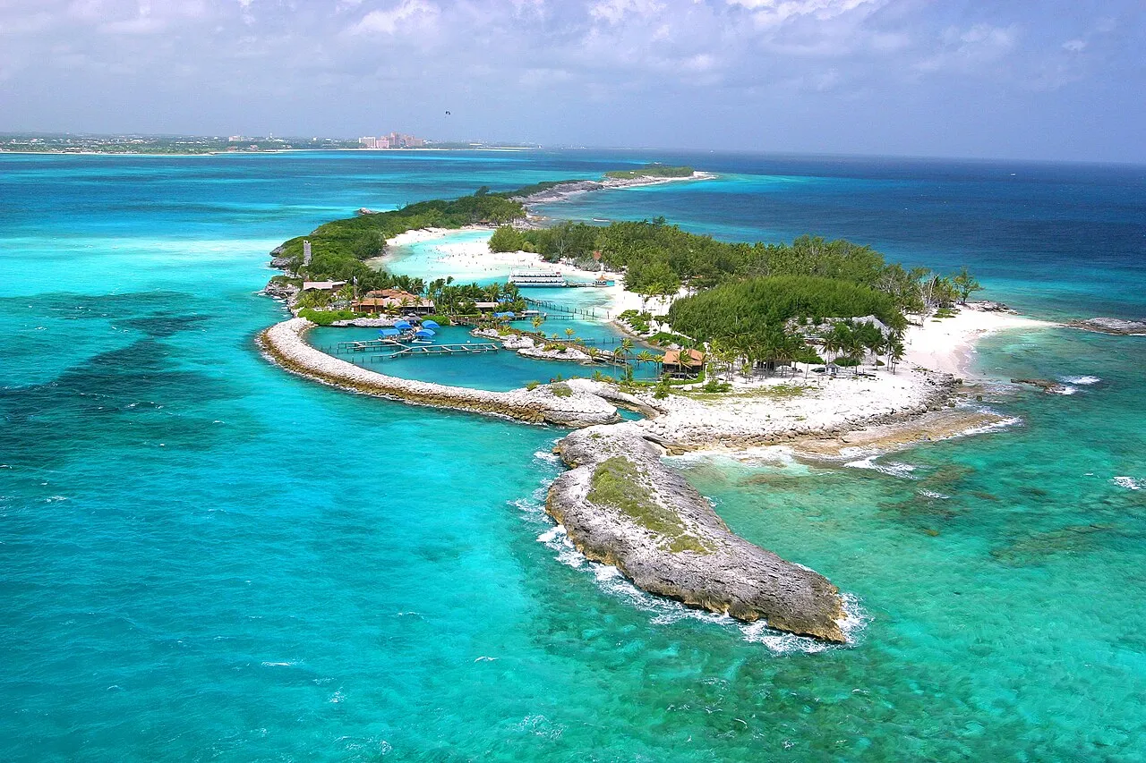 Aerial view of Blue Lagoon Island off Nassau, Bahamas, showing turquoise water surrounding the small private island.