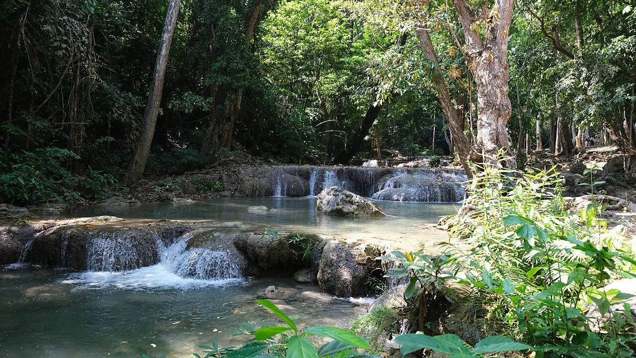 The tiered cascades and clear emerald pools of Erawan Waterfall in Erawan National Park.