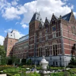brown concrete building near green grass field during daytime