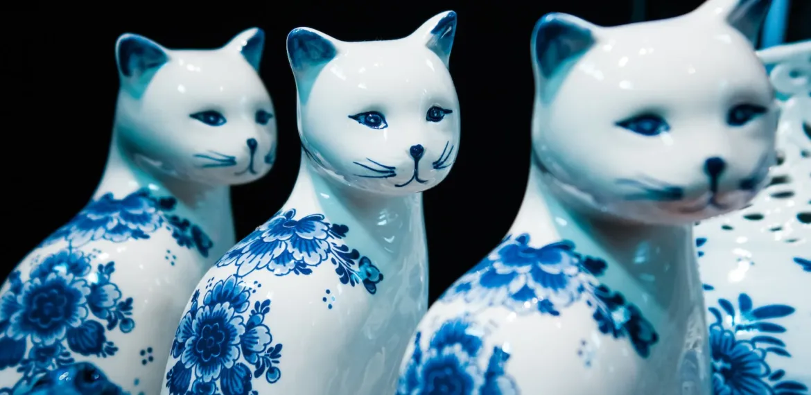 white and blue floral ceramic cat figurines