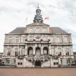 white and brown concrete building under white clouds during daytime