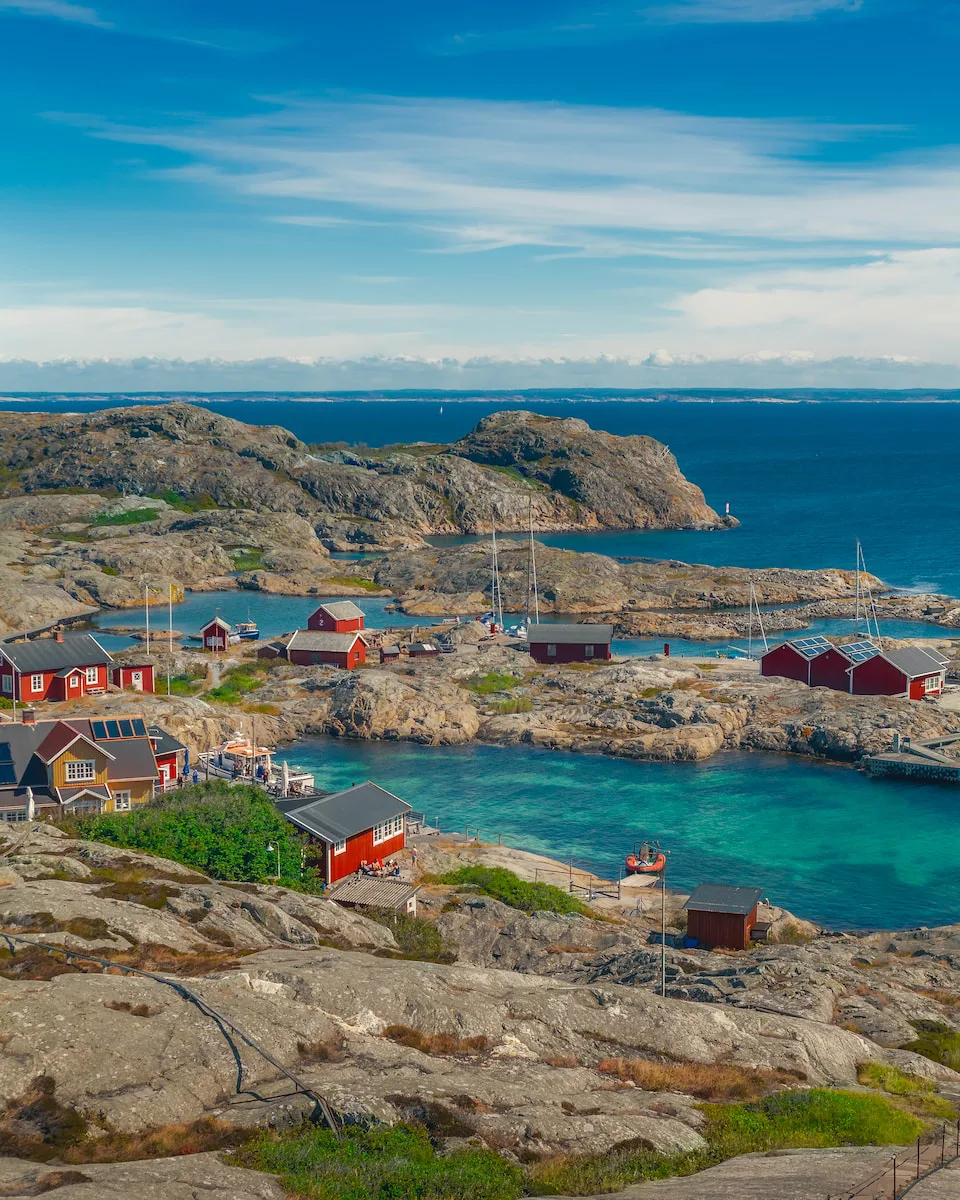 Red wooden boathouses and sailing boats on bare granite skerries in the Gothenburg archipelago on the Swedish west coast